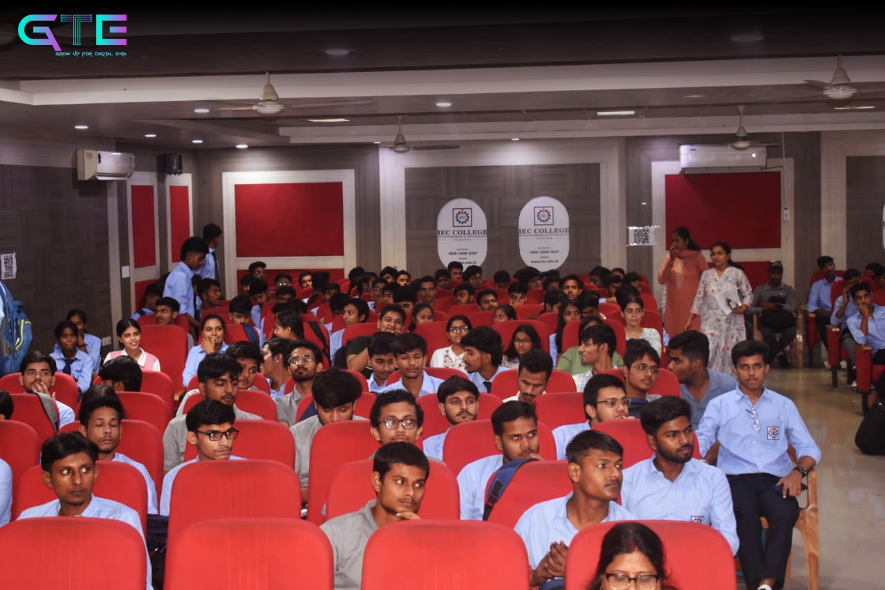 Large auditorium filled with students during an IEC session